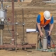 Image of a worker testing the soil