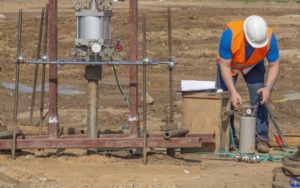 Image of a worker testing the soil on a construction site