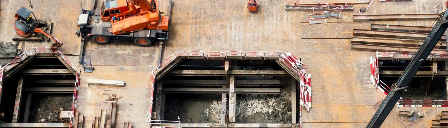 Image of machinery being used to excavate a top-down construction site.