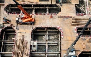 Image of machinery being used to excavate a top-down construction site.