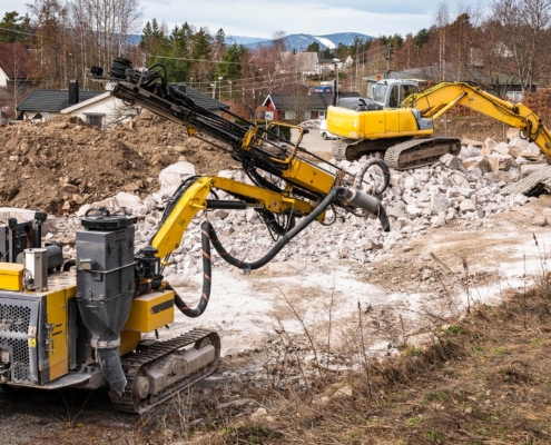 Excavator and drilling machine