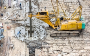 hydraulic drilling machines and workers on construction site