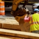 Back view of an excavator digging into city streets