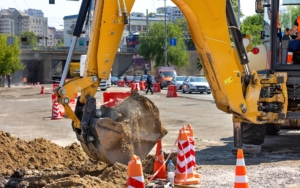 Side view of an excavator digging at a construction site
