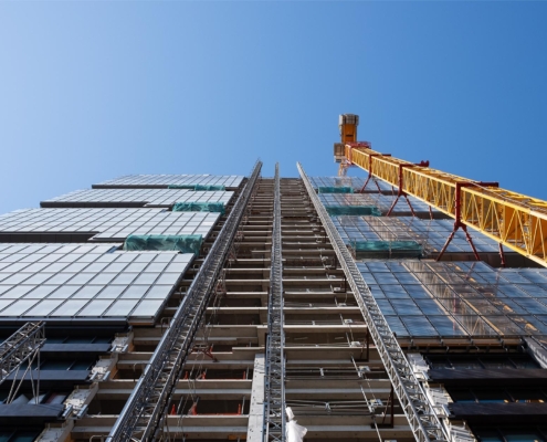 Worm's eye view of construction being done on a high rise building