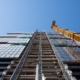 Worm's eye view of construction being done on a high rise building